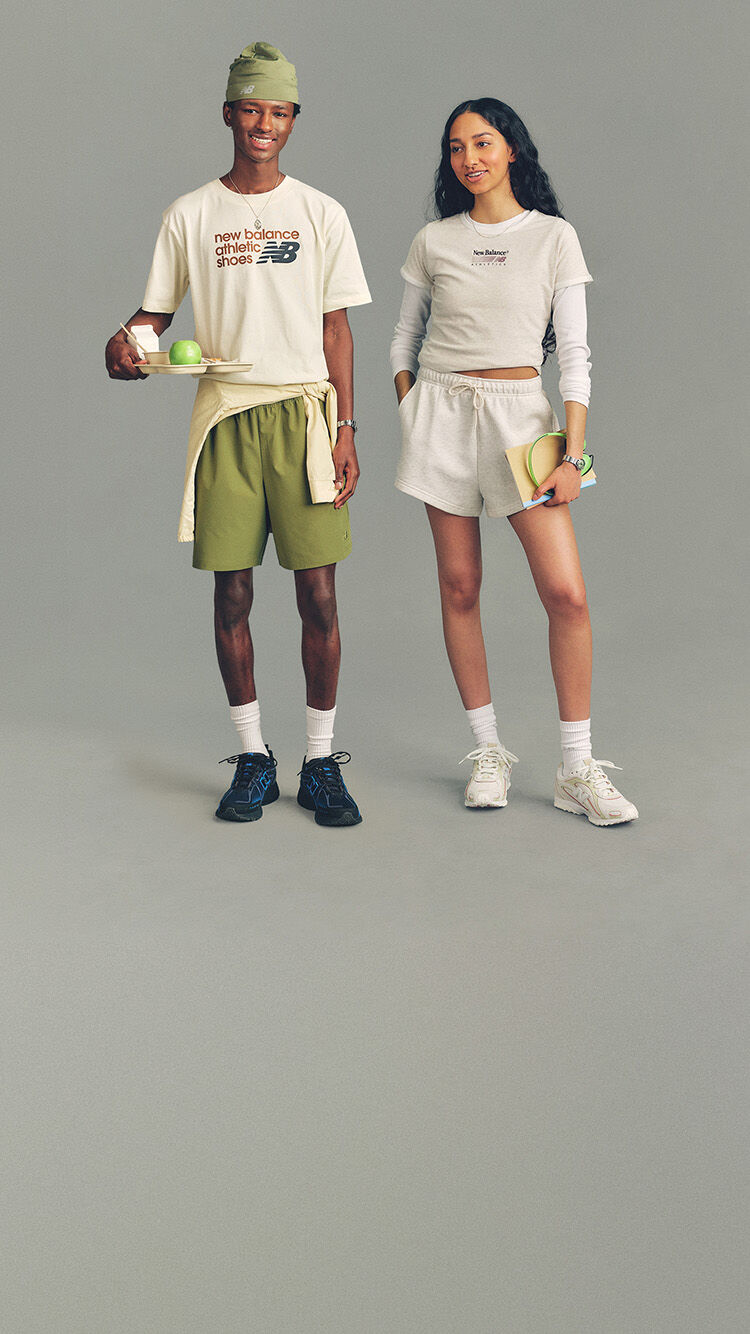 Two people standing dressed in Lifestyle apparel and footwear